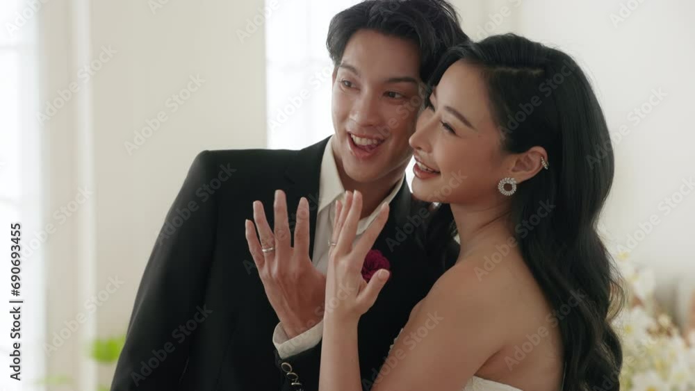 Elegant Couple Showcasing Wedding Rings in Sunlit Room Elegant Couple Showcasing Wedding Rings in Sunlit Room