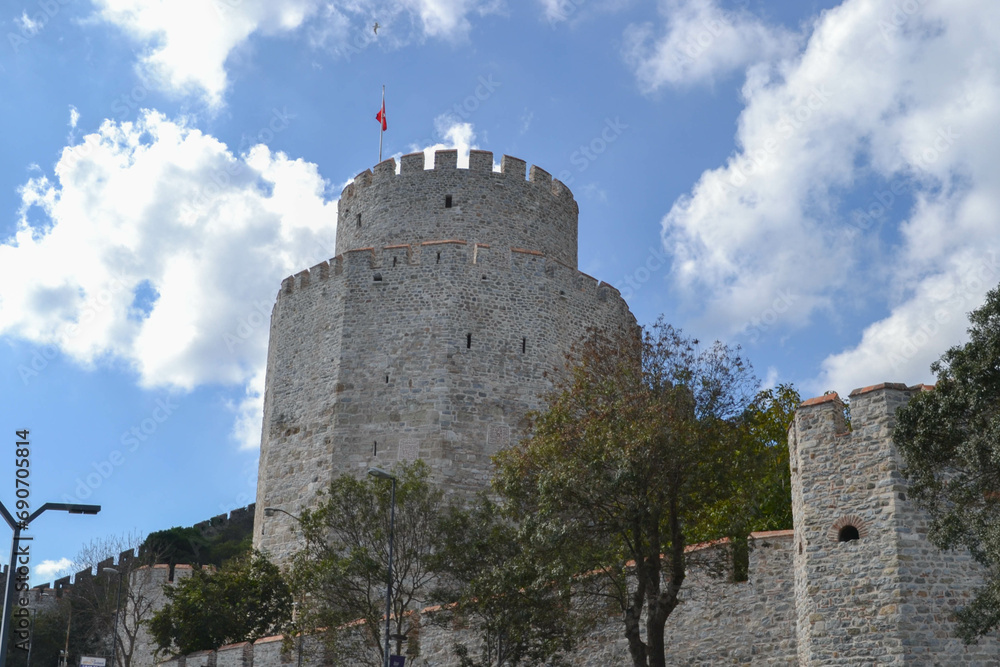 Turkish flag flies over a tower of Rumeli Hisari, Sariyer/Istanbul, Turkey, a fortress built during the fifteenth century to conquer Constantinople by Sultan Mehmed II.