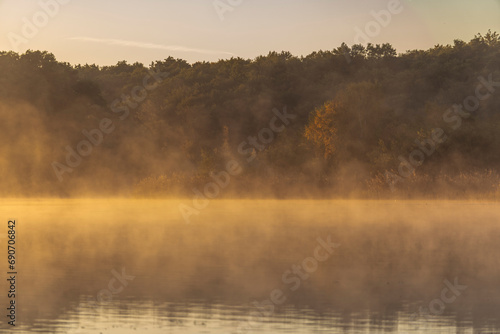 Dawn scenery in fall at a foggy lake near Waren, Muritz, Germany