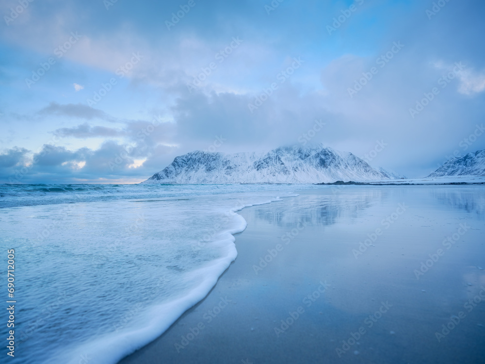 Mountains, beach and wave. Skagsanden beach, Lofoten islands, Norway. Winter landscape near the ocean. Norway travel image