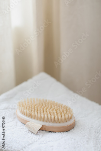 Body massage brush on white towel. body care product natural materials  zero waste  spa body care concept. Eco-friendly lifestyle