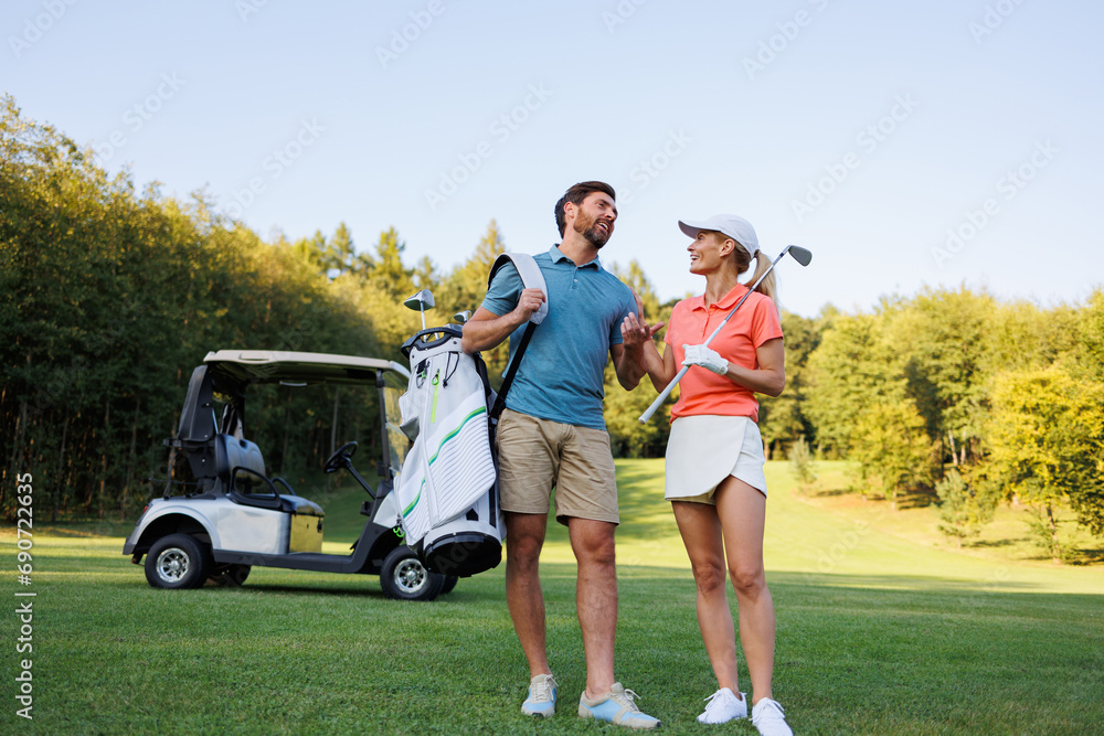 Elegant Golfer Duo Engaging in Golf Course Play