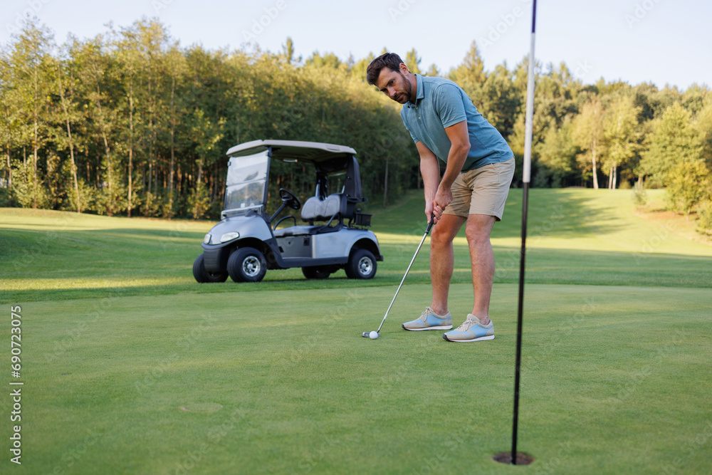 Fototapeta premium Golfer Close to the Last Hole with Cart and Club