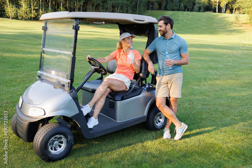 Refreshing Break: Couple Hydrating on Golf Course