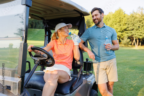 Stay Hydrated: Young Couple on Golf Cart at Course