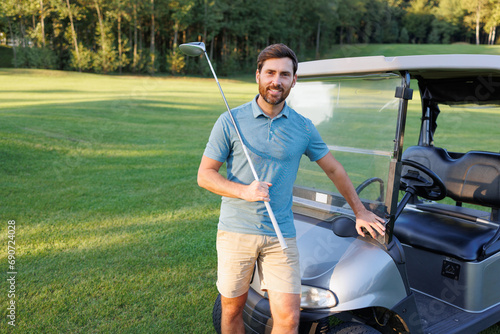 Golfer Poses by Golf Cart with Club