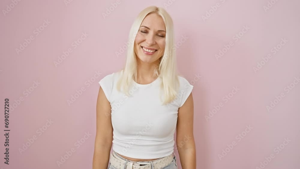 Young blonde lady, comically standing over isolated pink background, making crazy fish face gesture! fun, funny expression plastered on lips Young blonde lady, comically standing over isolated pink background, making crazy fish face gesture! fun, funny expression plastered on lips