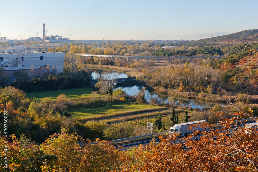 Autumn landscape in the vicinity of Monfalcone, Italy, with the motorway in the foreground and the power plant, the shipyard and the town in the background