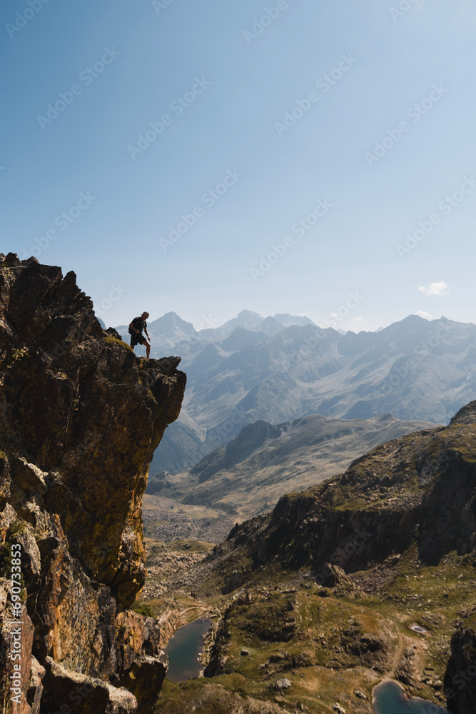 Mountaineer enjoys the spectacular cliff precipice in the Pyrenees in summer