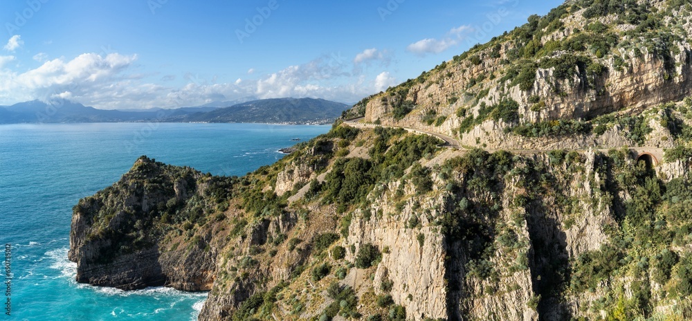 landscape view of the Costa di Maratea with a narrow and winding coastal highway in the cliffside