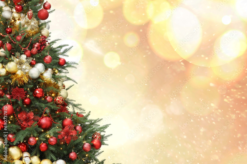 Christmas tree decorated with red and golden festive balls against blurred background, bokeh effect. Space for text