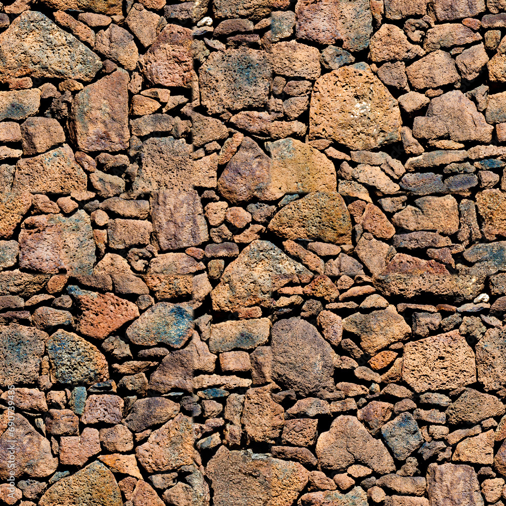 Cracked stone wall in arid climate with rough textured rock. Cracked stone wall in arid climate with rough textured rock.