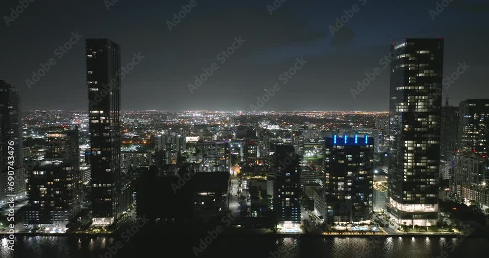 Miami Brickell in Florida, USA at night. Aerial view of brightly illuminated American downtown office district. High commercial and residential skyscraper buildings in modern US megapolis Miami Brickell in Florida, USA at night. Aerial view of brightly illuminated American downtown office district. High commercial and residential skyscraper buildings in modern US megapolis