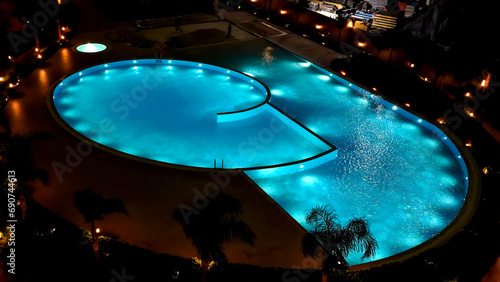 An illuminated pool with modern architecture and night lights    photo