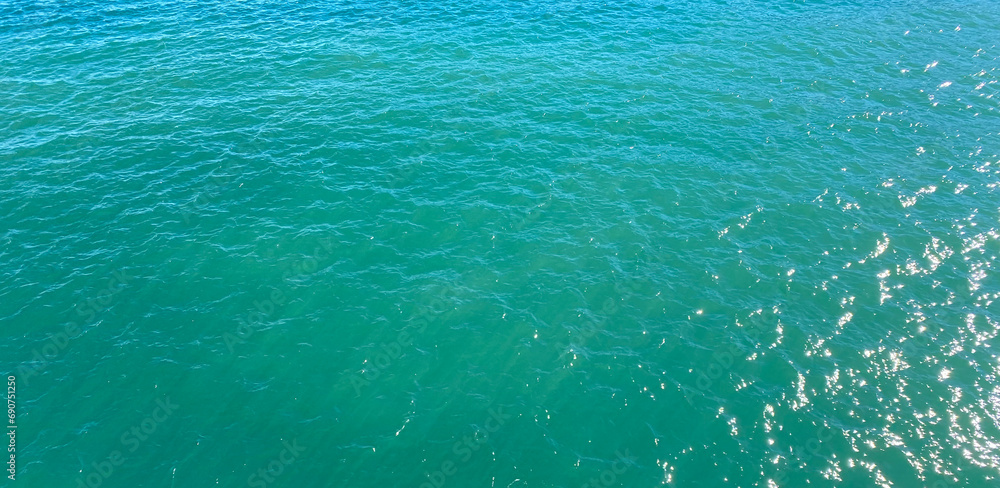 Turquoise sea water surface texture background. Top view of the sea.