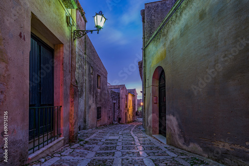 A characteristic alley of the Erice medieval town at nightfall  Sicily