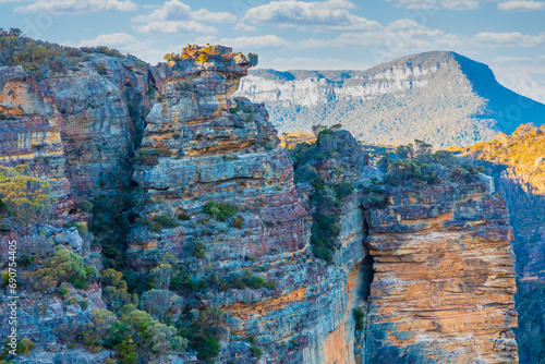 Photograph of the rugged and rocky cliff face of mountains the Megalong Valley in the Blue Mountains in New South Wales in Australia photo