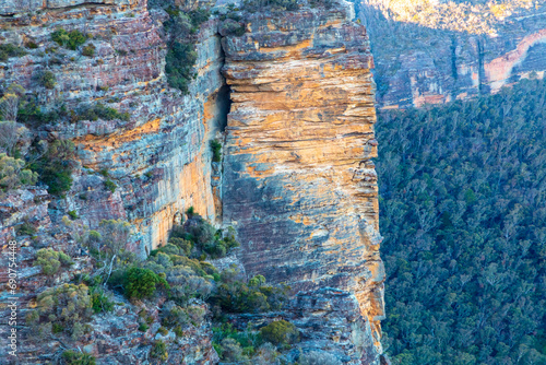 Photograph of the rugged and rocky cliff face of mountains the Megalong Valley in the Blue Mountains in New South Wales in Australia photo