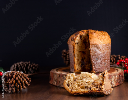 Slice of delicious Panettone with chocolate for Christmas. On wooden table