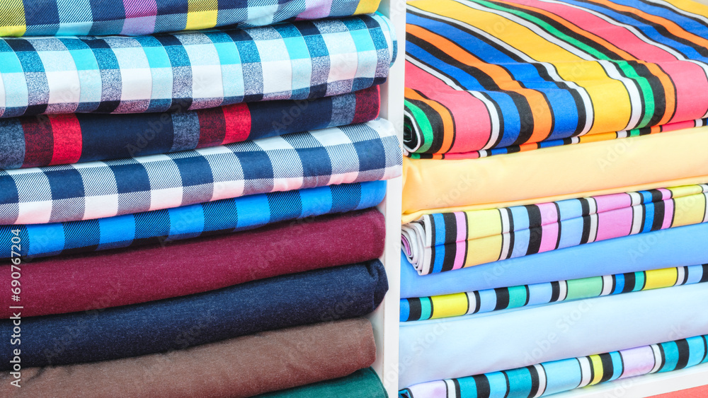 Multi-colored patterned fabric lies on pegs in the store Multi-colored patterned fabric lies on pegs in the store