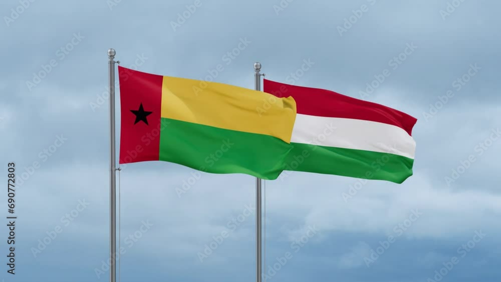 Hungary flag and Guinea-Bissau flag waving together on cloudy sky, endless seamless loop, two country relations concept Hungary flag and Guinea-Bissau flag waving together on cloudy sky, endless seamless loop, two country relations concept