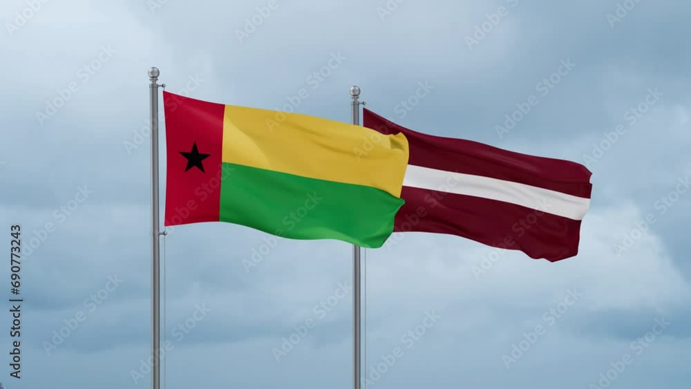 Latvia and Guinea-Bissau flag waving together on cloudy sky, endless seamless loop, two country cooperation concept Latvia and Guinea-Bissau flag waving together on cloudy sky, endless seamless loop, two country cooperation concept