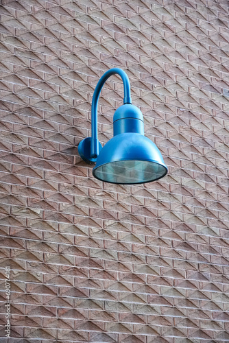 Close up of blue color lantern on red brick textured wall, Roterman city district, Tallinn, Estonia, Europe photo