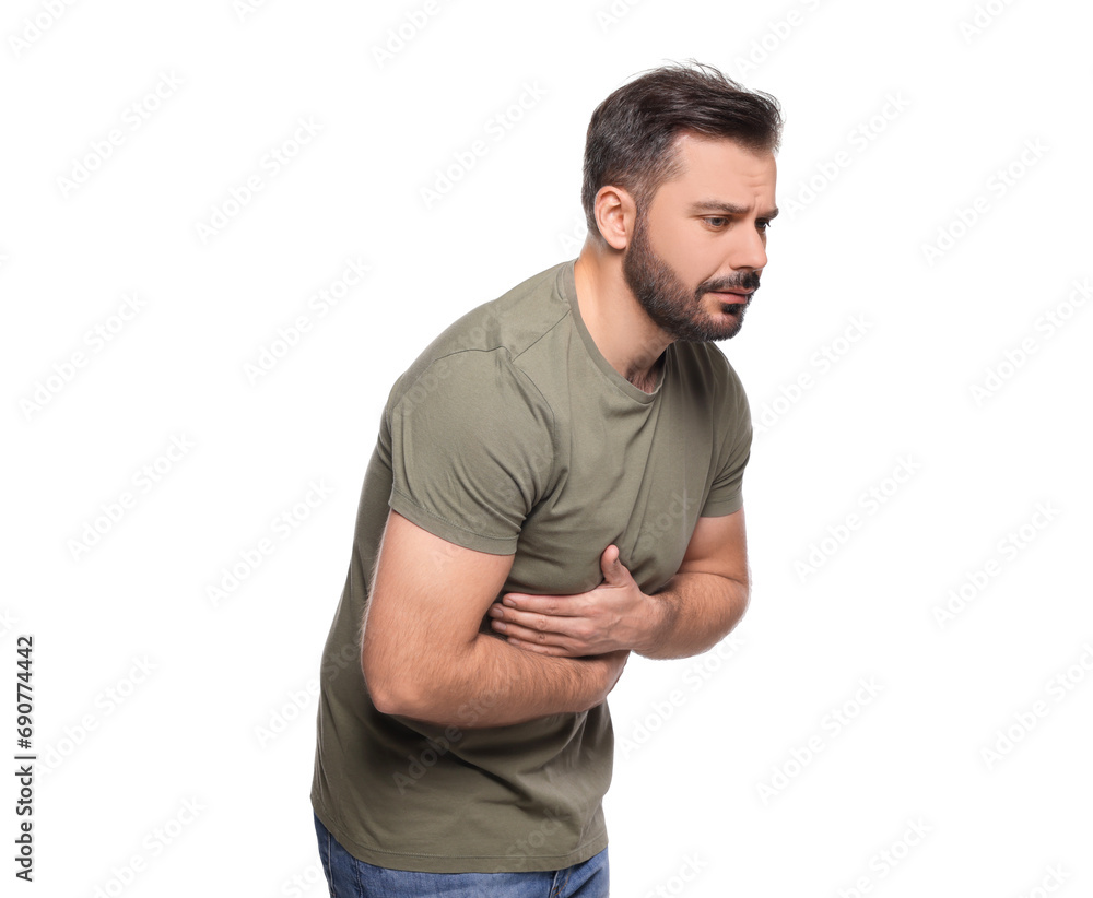 Obraz premium Unhappy man suffering from stomach pain on white background