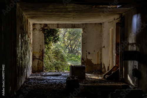 A spacious room of an abandoned former company in a dilapidated building with no access door