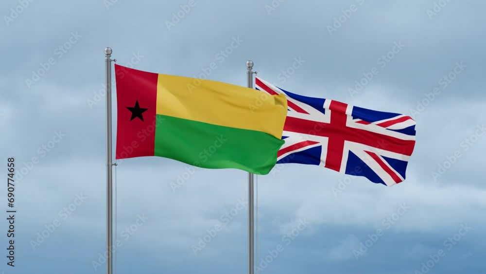 United Kingdom and Guinea-Bissau flag waving together on cloudy sky, endless seamless loop, two country cooperation concept United Kingdom and Guinea-Bissau flag waving together on cloudy sky, endless seamless loop, two country cooperation concept