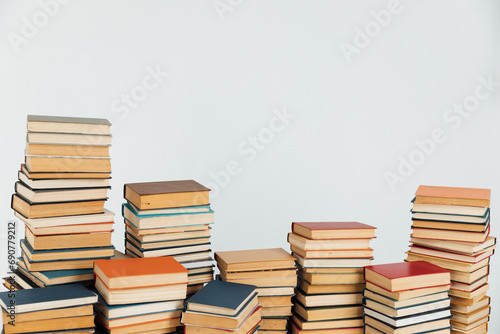 Stacks of educational books in university library on white background