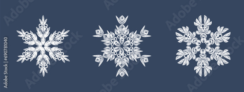 A set of stylish white quilling snowflakes on a dark blue background. Paper openwork weaving technique. Elements of quilling. New Year's symbols in the pattern. photo