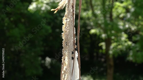 Dream catcher and green trees on the background.