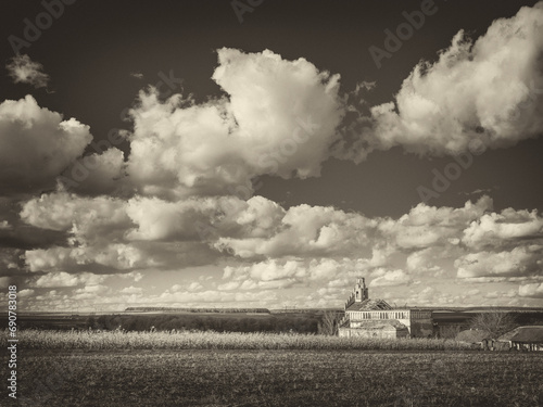 landscape with abandoned cathedral and clouds above field in vintage style © sergejson