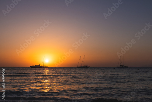 Three Sailboats at Sunset. © MCStock