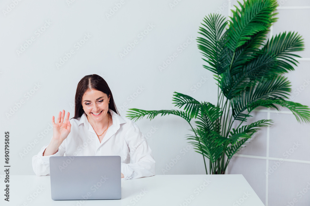 Business woman online on laptop from office Business woman online on laptop from office