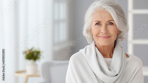 Smiling middle aged mature pensioner grey haired woman looking at camera. happy old lady posing at modern home indoor. positive single senior retired female in living room headshot portrait AI photo