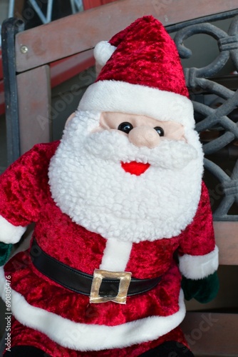 Plush Santa Claus Decoration on a Wooden Bench