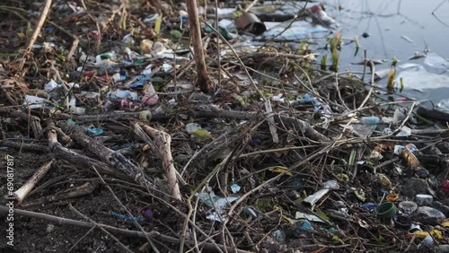 garbage piled in the water lake canal