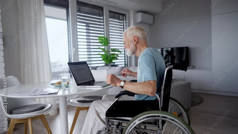 Senior man in a wheelchair working during retirement. Senior man in a wheelchair working during retirement.
