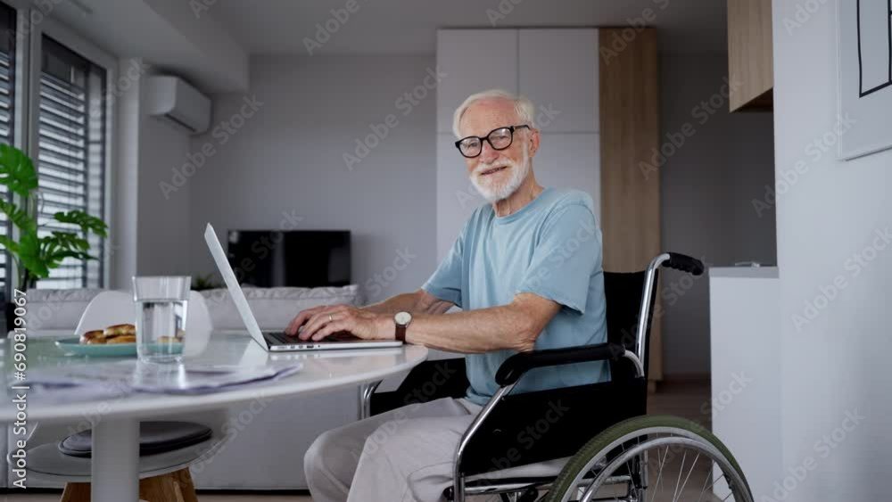 Senior man in a wheelchair working during retirement. Senior man in a wheelchair working during retirement.