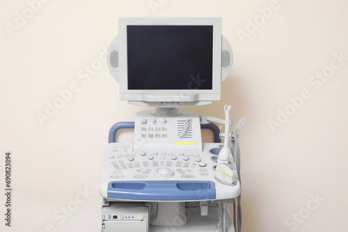 Ultrasound machine near white wall. Medical equipment