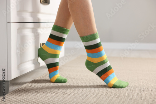 Woman in stylish colorful socks indoors, closeup