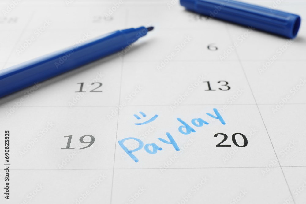 Blue felt pen on calendar page with marked payday date, closeup Blue felt pen on calendar page with marked payday date, closeup
