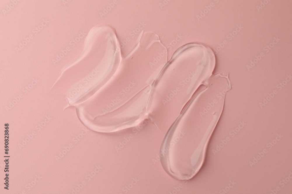 Sample of clear cosmetic gel on pink background, top view Sample of clear cosmetic gel on pink background, top view