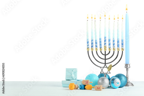 Hanukkah celebration. Composition with menorah, dreidels and gift boxes on table against white background