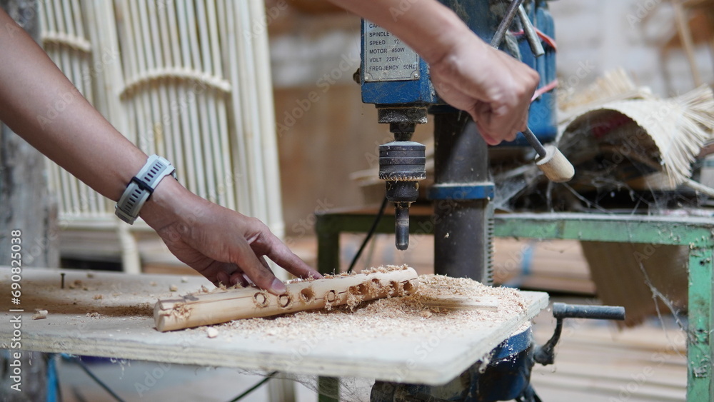 a worker with a wood drill a worker with a wood drill