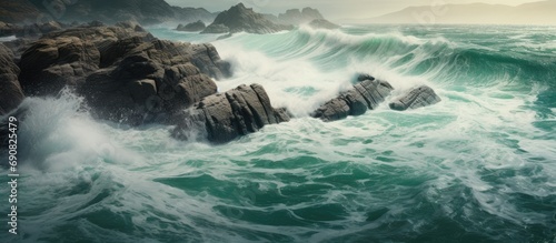 the ocean with waves crashing against the rocks