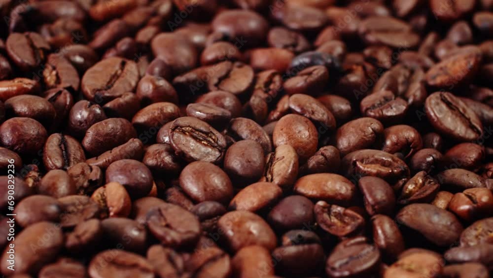 Coffee Beans Rotate in a Pile. Close-up of Roasted Coffee Beans. Coffee Beans Rotate in a Pile. Close-up of Roasted Coffee Beans.