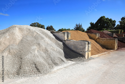 Large quantities of different landscaping rocks, recycled concrete, stones, sand and fill for sale at a local supply shop.
